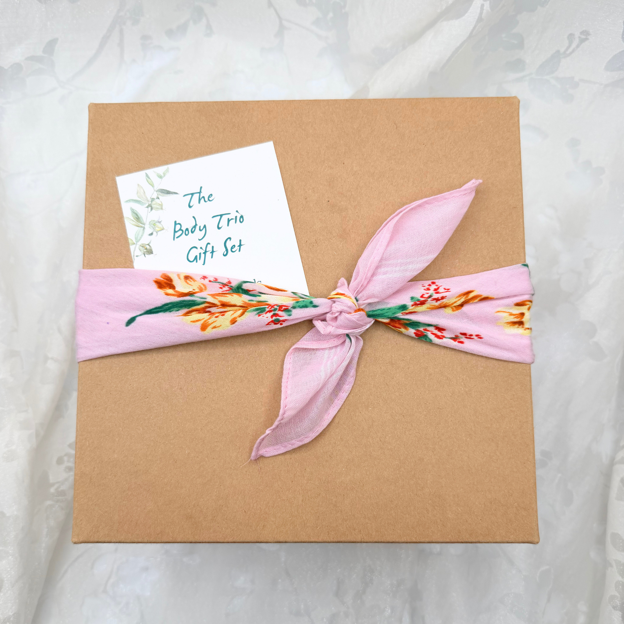 Gift Box tied with floral cotton bandana and 'The Body Trio Gift Set' gift tag.