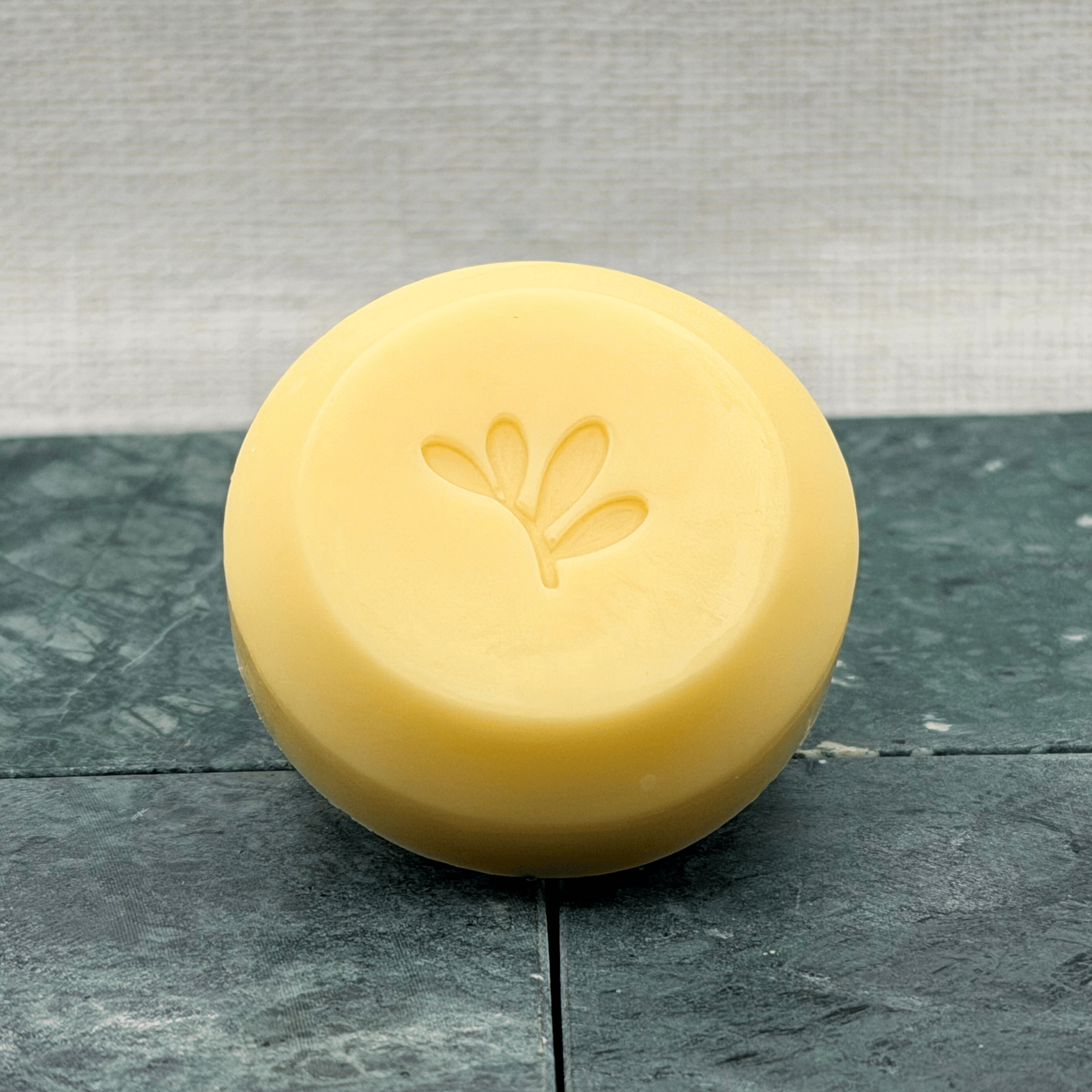 Refill moisturizing bar on marble surface with linen background.